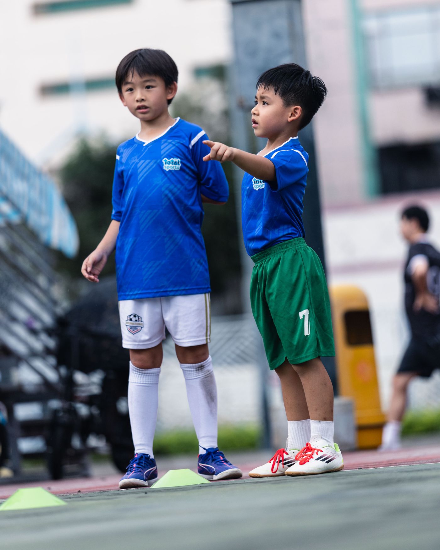 Student sprinting in a Total Sports shirt