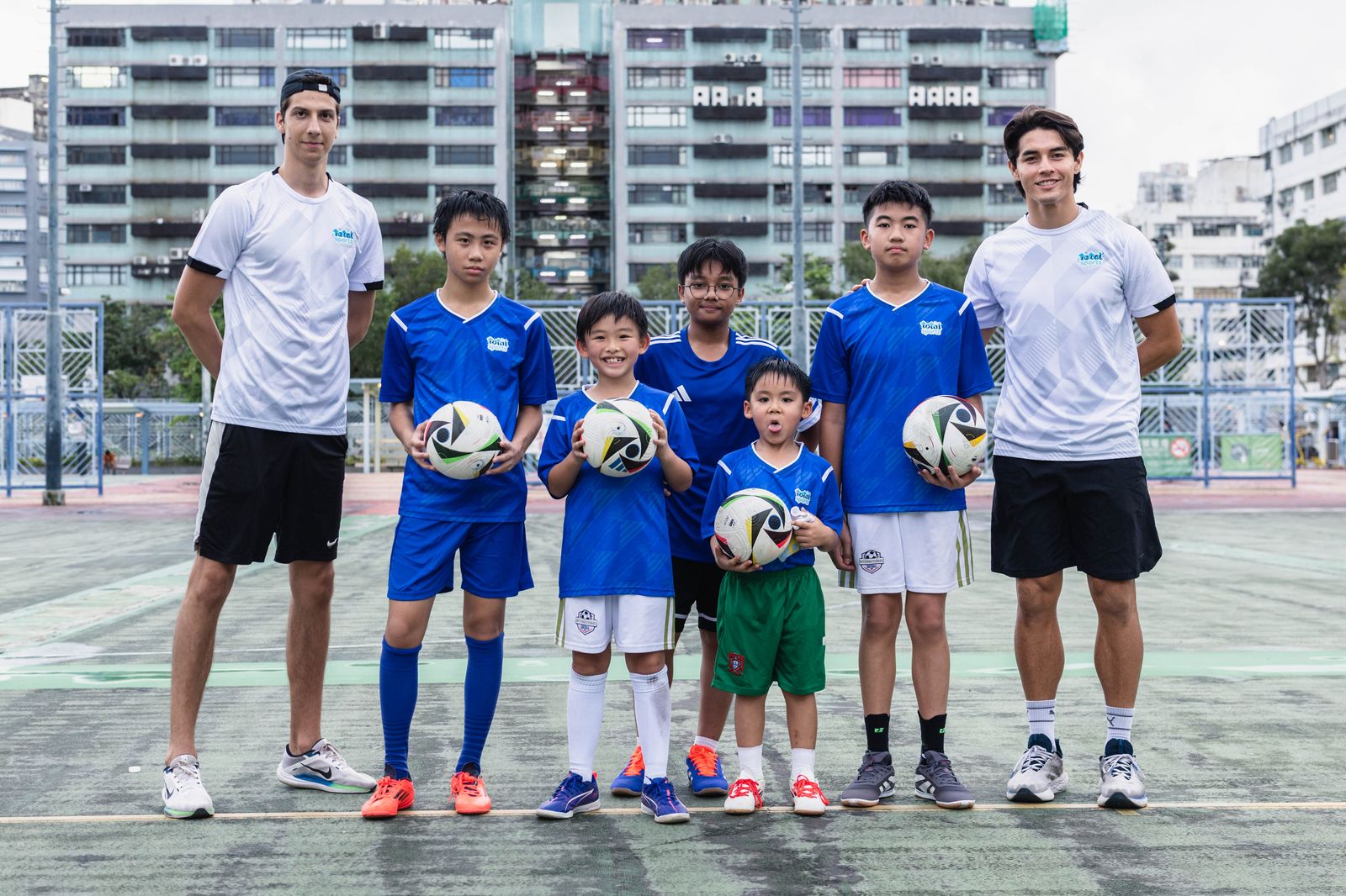 Squad and coaches with match balls