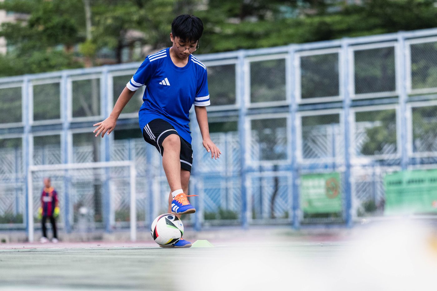 Student turning with the ball between cones