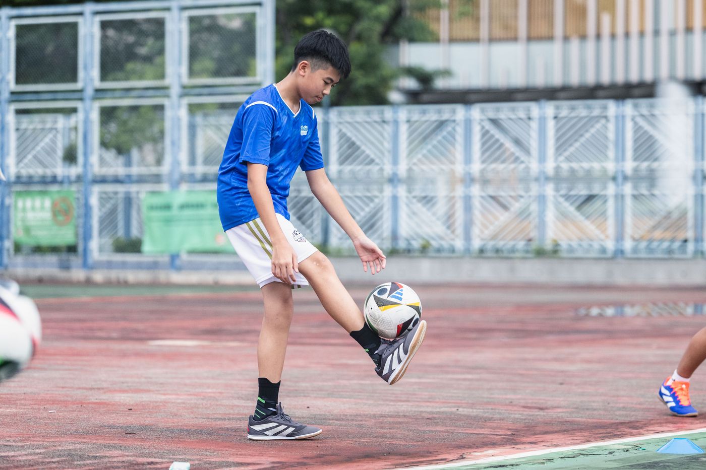 Secondary student striking a ball